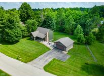 Lovely home featuring mature trees, a detached garage, and well-maintained landscaping at 155 Hoover Dr, , IN 46164