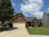 Charming brick home featuring an attached two-car garage and well-maintained landscaping in a residential area at 1820 Irish Lake Ln, Indianapolis, IN 46239