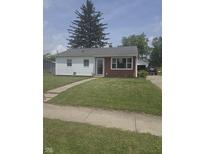 Charming ranch-style home featuring a well-maintained lawn, inviting curb appeal, and tidy landscaping at 206 Allen Ln, Greenfield, IN 46140
