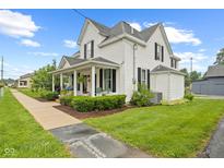 Charming white two-story home with black shutters and a cozy front porch at 211 N County Line Rd, , IN 47272