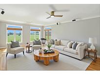 Bright living room with a fan, plush seating, large windows, and a view of the outdoors at 2251 Somerset Dr, Franklin, IN 46131
