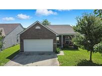 Charming brick home with an attached two car garage and well-manicured front lawn, perfect for suburban living at 2253 Bridlewood Dr, Franklin, IN 46131