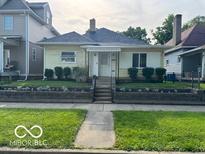 Charming one-story home featuring a landscaped yard and inviting front porch at 2830 Guilford Ave, Indianapolis, IN 46205