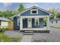 Charming blue house with a welcoming front porch and well-maintained landscaping at 3562 E Morris St, Indianapolis, IN 46203