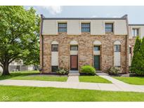 Brick townhome with well-maintained lawn and sidewalk leading to the front doors at 49 Druid Hill Ct # 0, Carmel, IN 46032