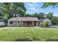 Charming single-story home featuring stone facade, flower beds, and well-manicured lawn at 5170 Mt Pleasant N St, Greenwood, IN 46142