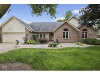 Charming single story brick home features a well manicured lawn and established landscaping at 5591 Royal Troon Way, Avon, IN 46123