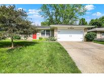 Charming single-story home with a well-maintained lawn and a bright red front door at 621 S Jefferson St, Brownsburg, IN 46112
