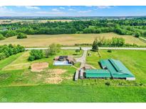 Expansive aerial view of a farm featuring a house, pool, barn, and lush green fields with mature trees at 7165 W State Road 252 W Rd, Edinburgh, IN 46124