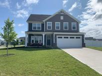 Charming two-story home with gray siding, white trim, a two-car garage, and a well-manicured lawn at 7270 W Stone Pass, New Palestine, IN 46163