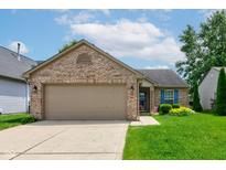 Charming single-story brick home with a two-car garage, manicured lawn, and a welcoming garden at 741 Chestnut Ln, Brownsburg, IN 46112