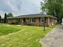 Charming brick ranch with well-maintained lawn and classic black shutters at 8061 Sycamore Springs Trl, Indianapolis, IN 46239