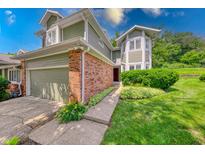 Inviting two-story home featuring a brick facade, attached garage, and well-maintained landscaping at 8178 Foxchase Cir, Indianapolis, IN 46256