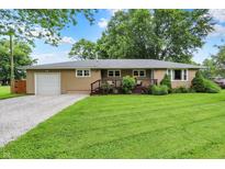 Charming one-story home featuring a well-manicured lawn, gravel driveway, and inviting front porch at 8760 Big Bend Rd, Martinsville, IN 46151