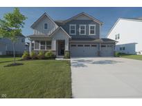 Charming two-story home featuring a well-manicured lawn and a spacious two-car garage at 11663 Winnower, Noblesville, IN 46060