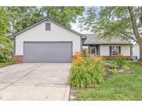 Charming single-story home featuring a well-maintained lawn and an attached two-car garage at 1540 Brook Pointe Dr, Indianapolis, IN 46234