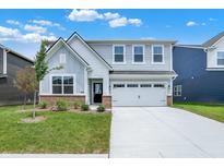 Charming two-story home with light-blue siding, white trim and a two car garage at 16929 Sandhurst Pl, Westfield, IN 46074