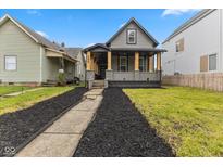 Charming two-story home with a welcoming front porch and well-maintained yard at 206 N Beville Ave, Indianapolis, IN 46201