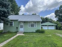 Charming single story home with a well-maintained lawn and detached two car garage in backyard at 2473 N Goodlet Ave, Indianapolis, IN 46222