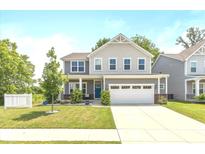Charming two-story home featuring a well-manicured lawn and attached two-car garage at 265 Gathering Ln, Greenwood, IN 46143