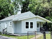 Charming home featuring light siding, a cozy front porch, and well-maintained landscaping at 3712 S Kealing S Ave, Indianapolis, IN 46237
