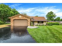 Charming single-story home featuring a brick and siding exterior with an attached two-car garage at 4070 Serenity Way Ct, Greenwood, IN 46142