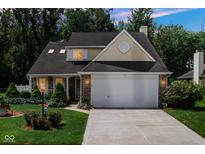 Charming home with a two-car garage, well-manicured lawn, and inviting curb appeal at 6439 Bower Dr, Indianapolis, IN 46241
