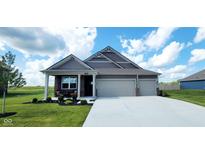 Beautiful single-story home with a landscaped yard and a three-car attached garage at 7808 Grande Oaks Dr, Plainfield, IN 46168