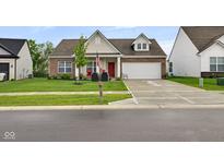 Charming single-Gathering home featuring a brick facade, well-manicured lawn, and an attached two-car garage at 9858 Bryce Blvd, Pendleton, IN 46064