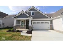 Charming home featuring stone accents, gray siding, and a convenient two-car garage at 10602 Maidenhair Dr, Indianapolis, IN 46239