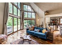Bright living room features large windows, hardwood floors, and a comfortable blue sofa with decorative pillows at 11544 Crestwood Ct, Indianapolis, IN 46239