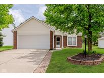 Charming single-story home with brick accents, a two-car garage, and a well-maintained lawn and landscape at 12121 Driftstone Dr, Fishers, IN 46037