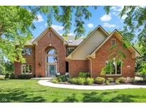 Beautiful brick home with well-manicured lawn and landscaping features, including a large window above the entrance at 1377 Sedona Dr, Carmel, IN 46032