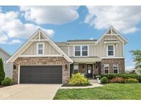 Charming two-story home with a brick and siding exterior and well-manicured lawn, showcasing curb appeal at 1414 W Springhurst Blvd, Greenfield, IN 46140