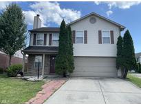 Charming two-story home features a two-car garage, brick accents, and manicured landscaping at 1503 Quinlan Ct, Indianapolis, IN 46217