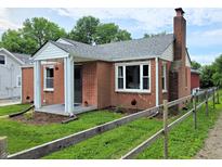Charming brick home featuring a cozy front porch and well-maintained landscaping at 160 E Elm St, Morgantown, IN 46160