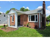 Charming brick home featuring a covered front porch, well-maintained lawn, and mature landscaping, offering inviting curb appeal at 160 E Elm St, Morgantown, IN 46160