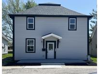 Charming two-story home with gray siding, black trim, and a covered front entryway at 1809 S H St, Elwood, IN 46036