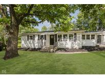Charming single-story home featuring a well-manicured lawn and inviting front entrance with a stately tree at 20797 Roberts Dr, Sheridan, IN 46069