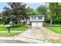 Charming two-story home featuring tidy landscaping, a two-car garage, and blue shutters at 317 Heritage Ct, Fishers, IN 46038