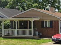 Charming single-story brick home with inviting front porch and well-maintained lawn at 3932 Millersville Dr, Indianapolis, IN 46205