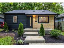 Charming home featuring a dark wood facade and a light wood accent wall creating a modern look at 4245 Norwaldo Ave, Indianapolis, IN 46205