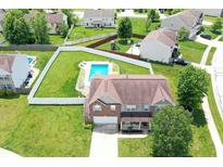Stunning aerial view of home with a pool, fenced yard, and well-manicured lawn at 5063 Haywood Ln, Plainfield, IN 46168