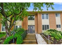 Charming brick condo exterior with well-maintained landscaping and accessible ramp to the front door at 526 W Hunters Dr # C, Carmel, IN 46032