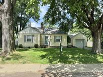 Charming bungalow with well-kept lawn and mature trees providing ample shade at 5378 Rosslyn Ave, Indianapolis, IN 46220