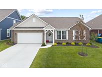 Charming brick home featuring a two-car garage and well-maintained landscaping at 5723 Arctic Run Dr, Noblesville, IN 46062