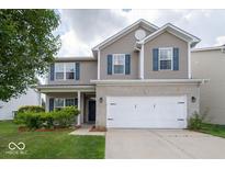 Charming two-story home featuring a brick and siding facade, complemented by a well-maintained front yard at 5859 Edelle Dr, Indianapolis, IN 46237