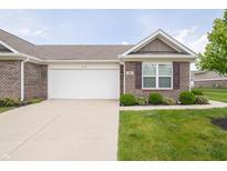 Charming brick home with a two-car garage, manicured lawn, and well-maintained landscaping at 610 Sawtooth St, Westfield, IN 46074