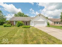 Charming single-story home featuring white siding, brick accents, an attached two-car garage, and a well-maintained lawn at 626 Tulip Poplar Ct, Mooresville, IN 46158
