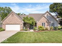 Charming brick home with a well-manicured lawn and a welcoming front entrance at 6528 Fountain Springs Blvd, Indianapolis, IN 46236